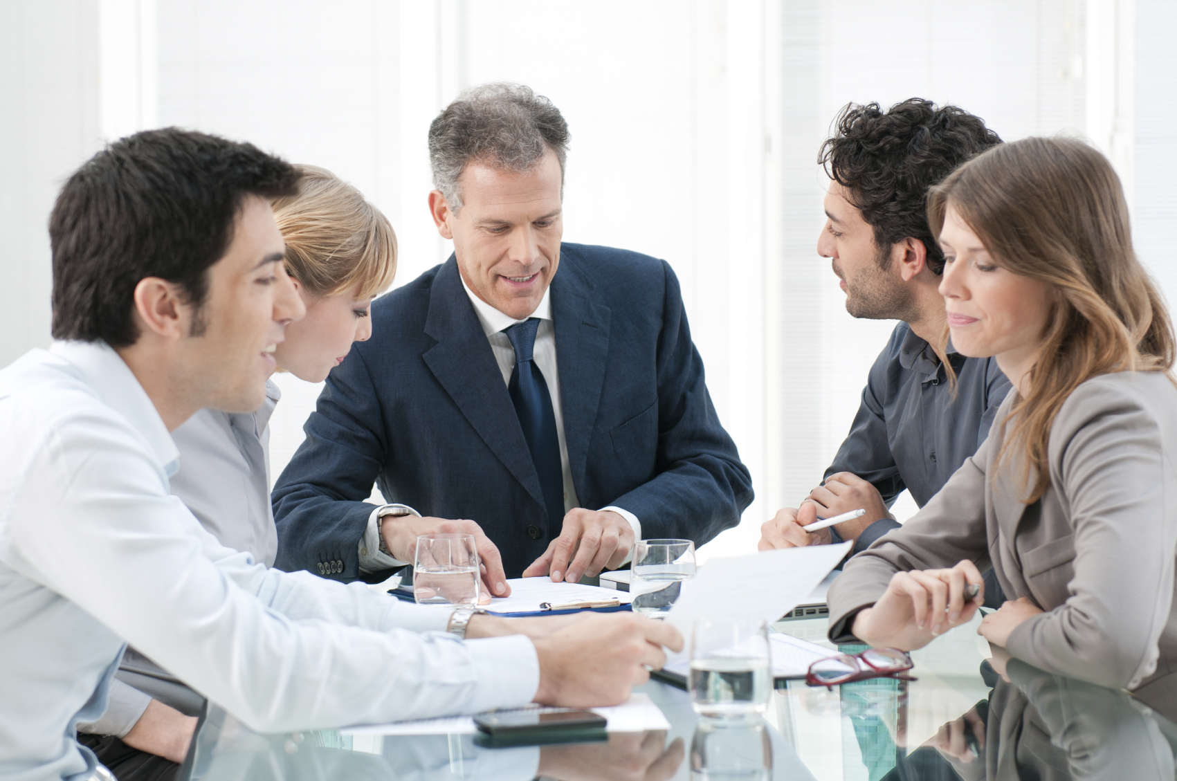 Business people work in group Mature businessman working and discussing with his colleagues at office